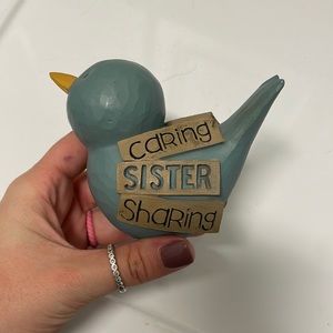 A Bird with “Caring Sister Sharing” Sign